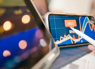 Trader examining Bitcoin Ethereum and forex options across several markets